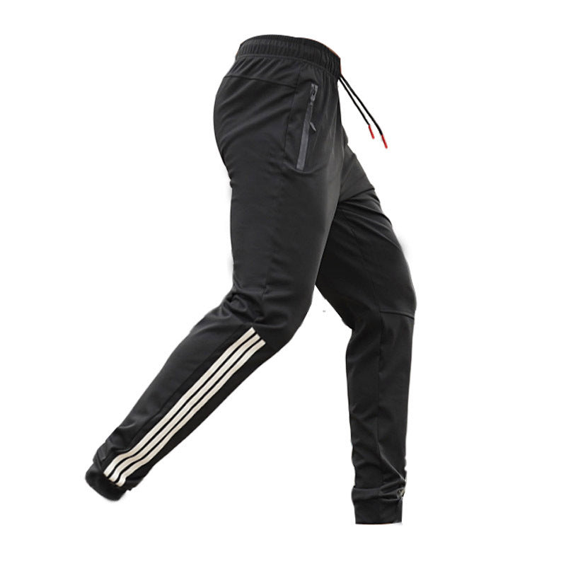Men's black slim casual pants with drawstring and white triple stripe detail