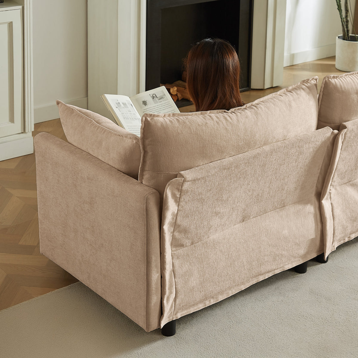 Beige sectional sofa with three throw pillows and square arms, upholstered for lounging.