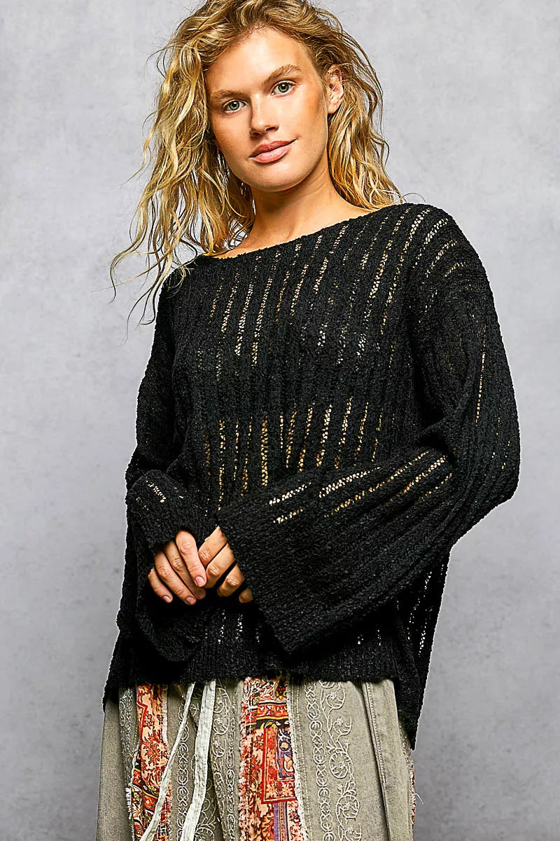 Black open-weave round-neck long-sleeve sweater with dropped shoulder, textured knit.