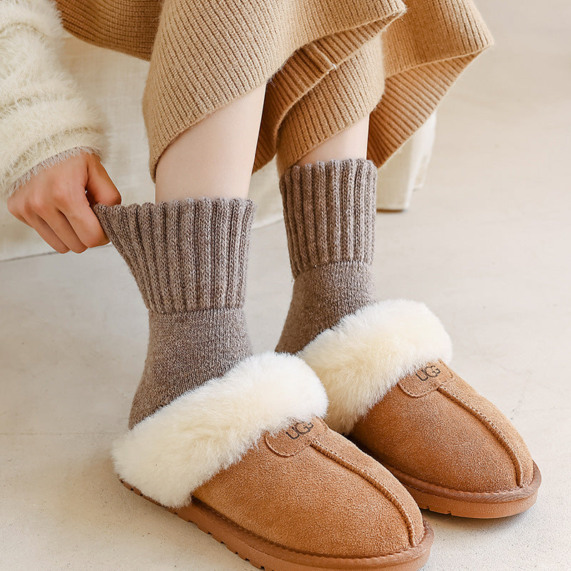 Children's thick wool tube socks in taupe and brown, worn with fuzzy slippers