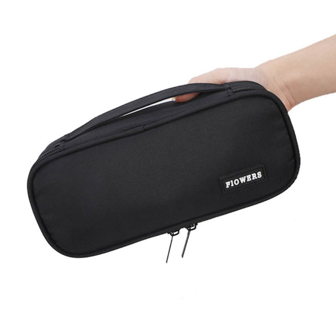 Black zipper pencil case with brand patch, held by hand