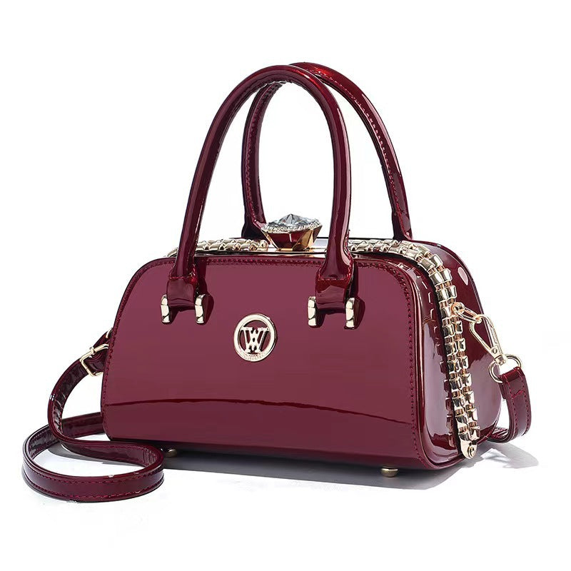 Wine red patent leather crossbody handbag with chain strap and front logo emblem