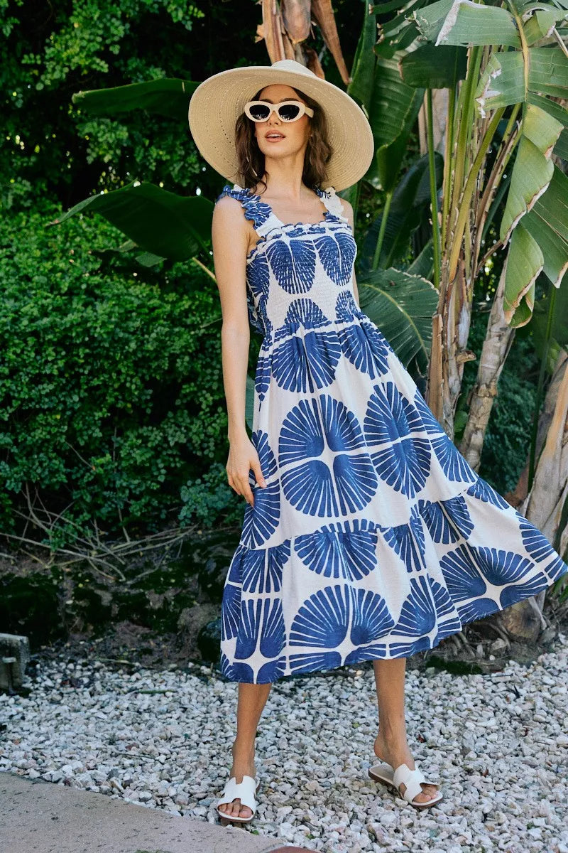 Front view navy and white abstract print tiered midi dress with smocked bodice