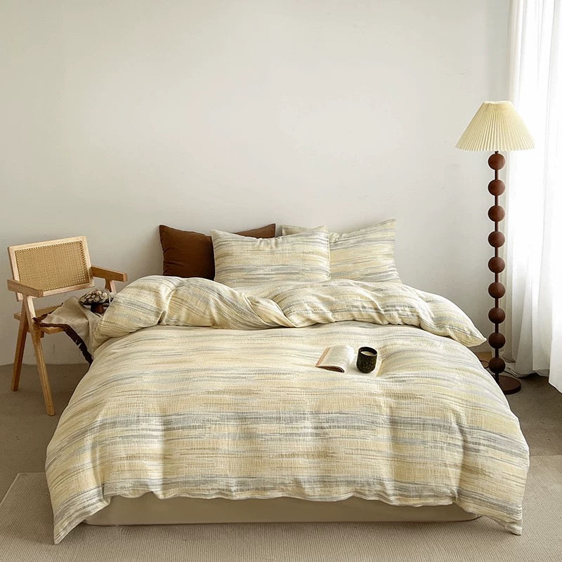 Textured duvet cover set with cream stripe duvet and matching pillow shams on bed