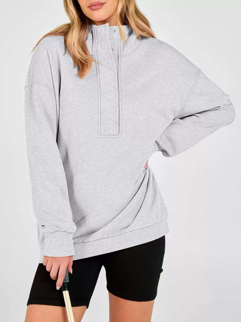 Light gray half-snap hoodie with long sleeves, hood, and front pocket