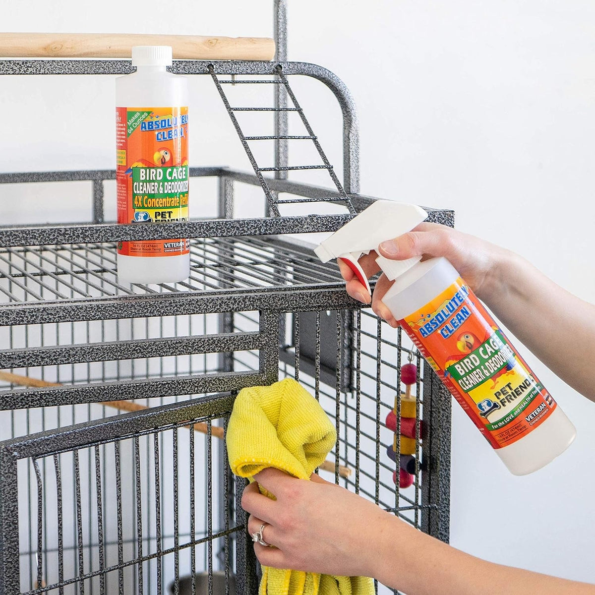 Bird cage cleaner and deodorizer spray used to clean a metal cage with a cloth
