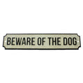 Cast iron sign: "BEWARE OF THE DOG" in white letters on light panel, black border.