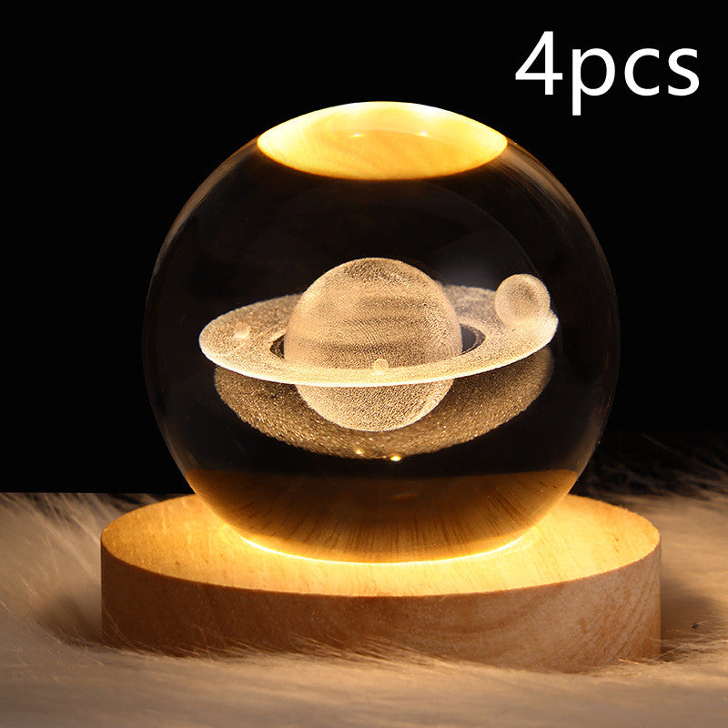 LED crystal ball table lamp on wood base with golden Saturn-like planet and rings