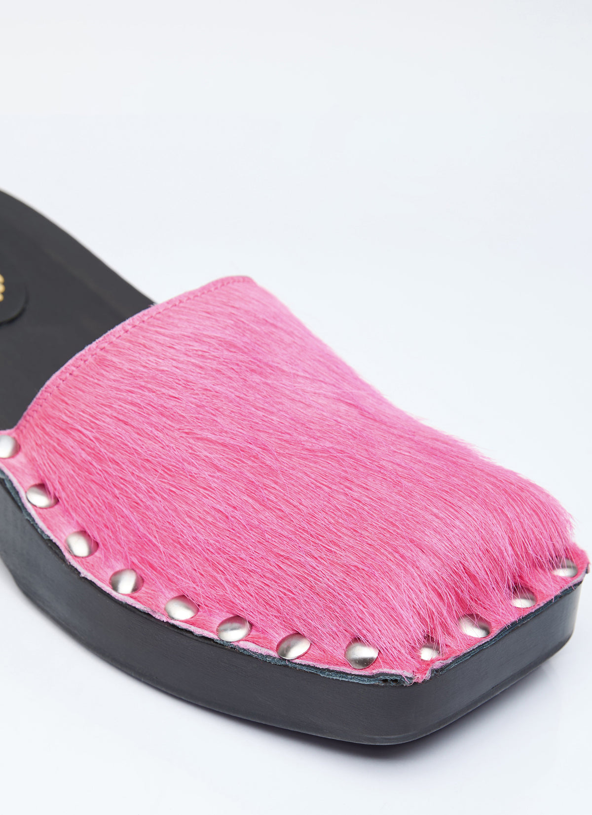Pink furry clog upper with studded eyelet trim and black platform sole