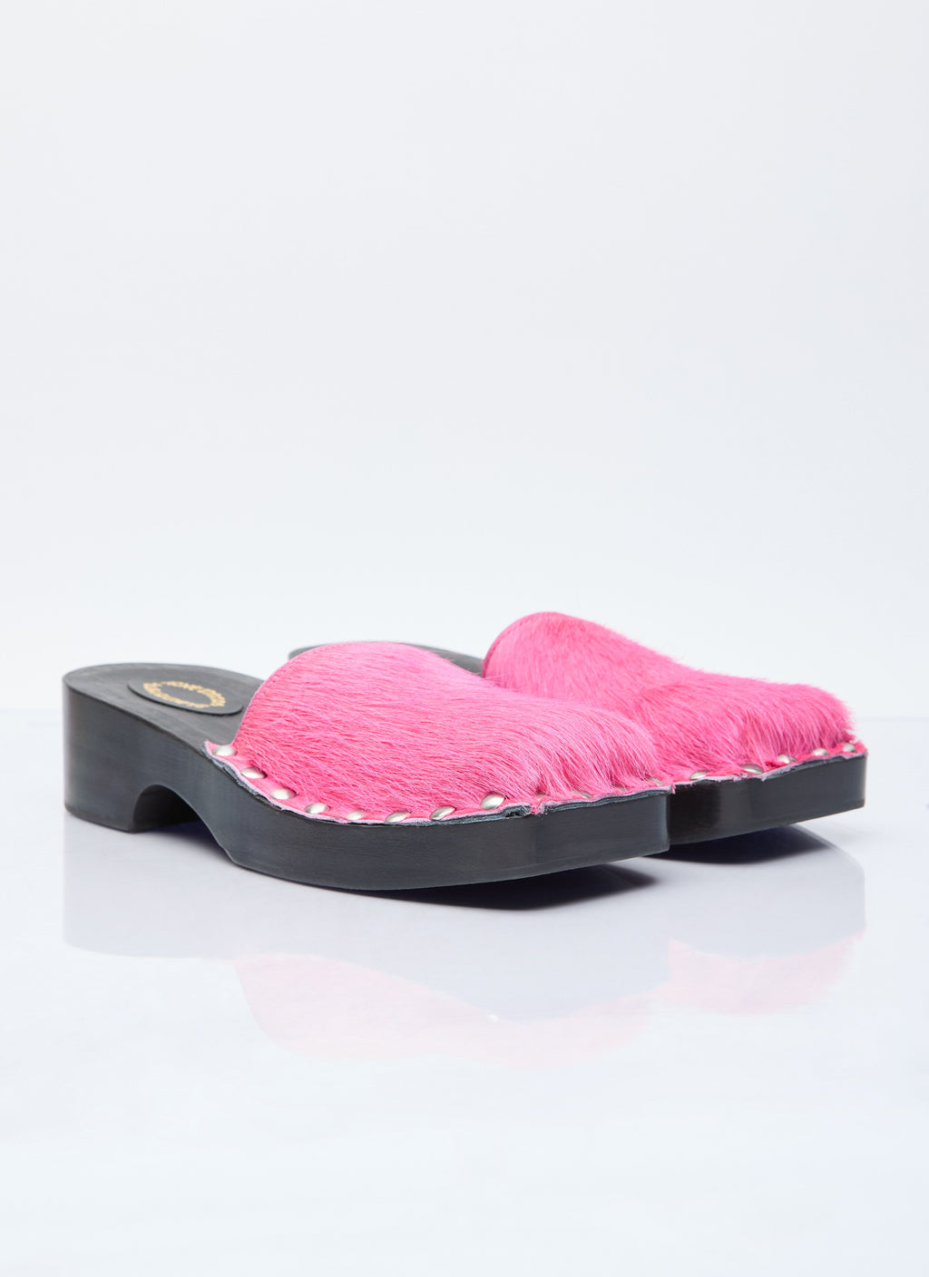 Pink furry open-back clogs on black block-heel platform sole