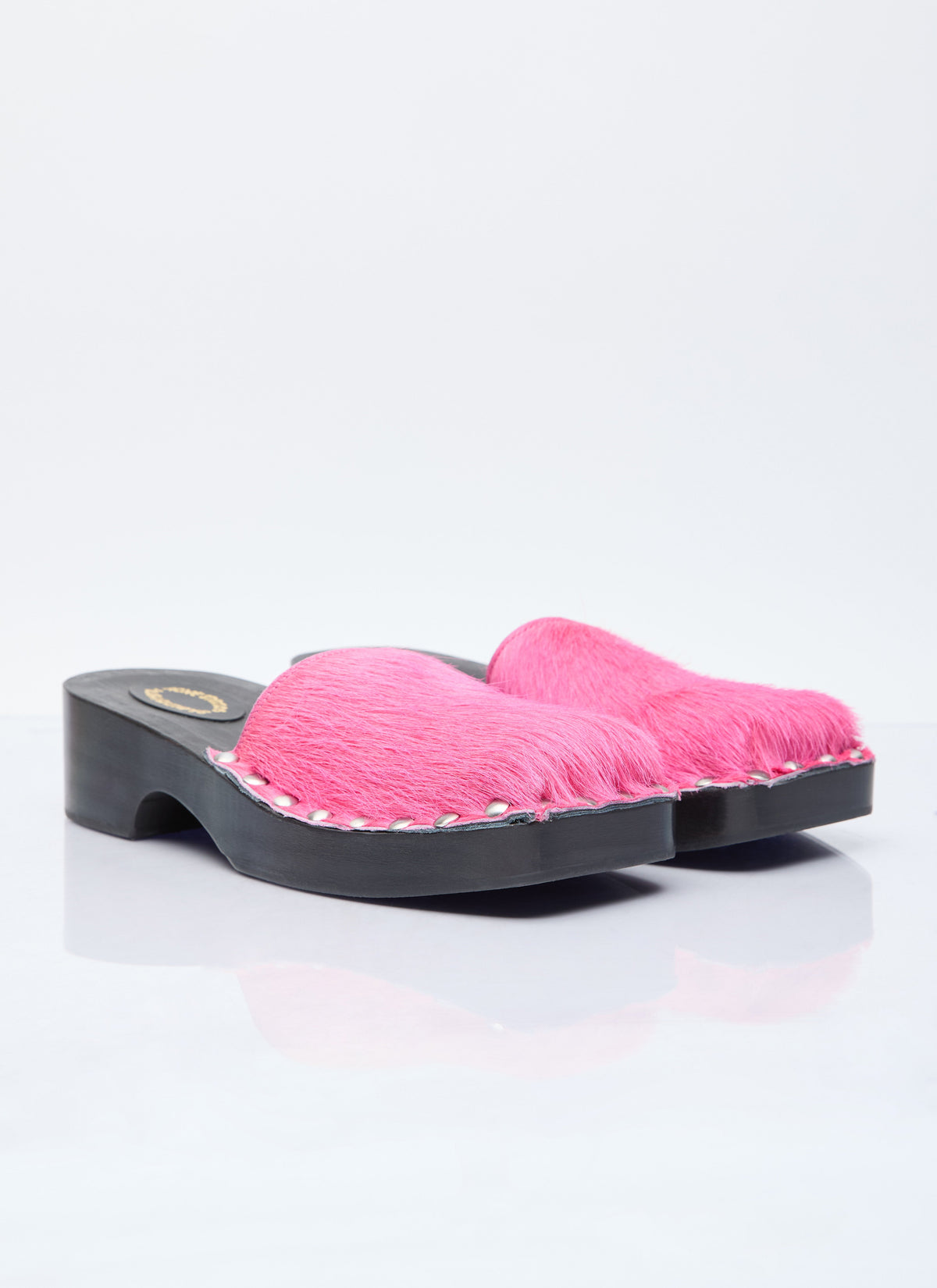 Pink furry open-back clogs on black block-heel platform sole