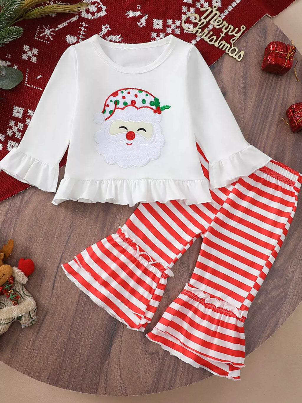 White Christmas ruffle-hem top with Santa face applique and red-and-white striped pants