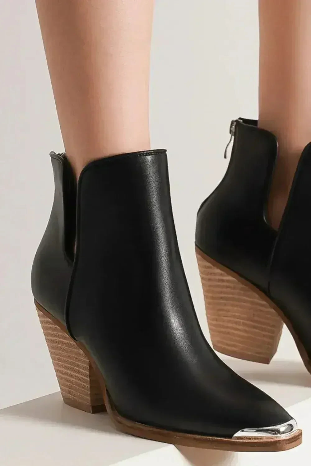Black faux-leather ankle boots with metallic toe cap and mid block heel, angled view