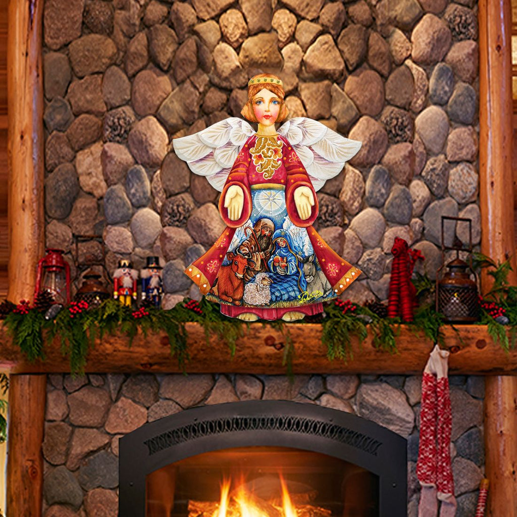 Nativity angel door decor: red robe, white wings, rings over nativity scene