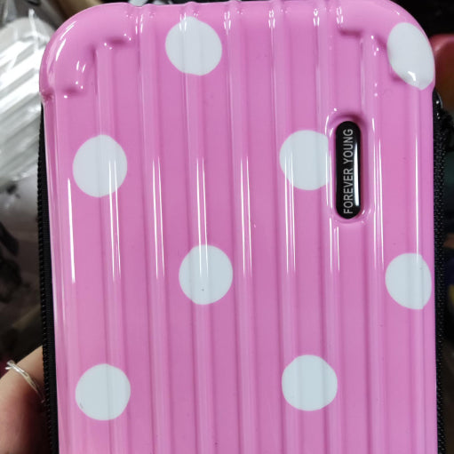 Cosmetic bag in pink with white polka dots and vertical side branding.