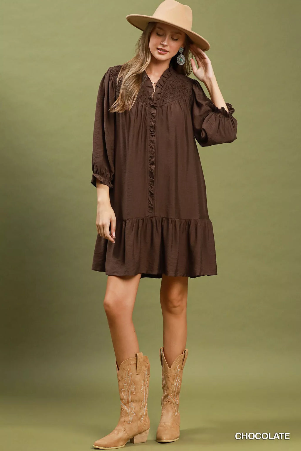 Chocolate-brown tiered mini dress with ruffled placket and skirt tiers, long puff sleeves.