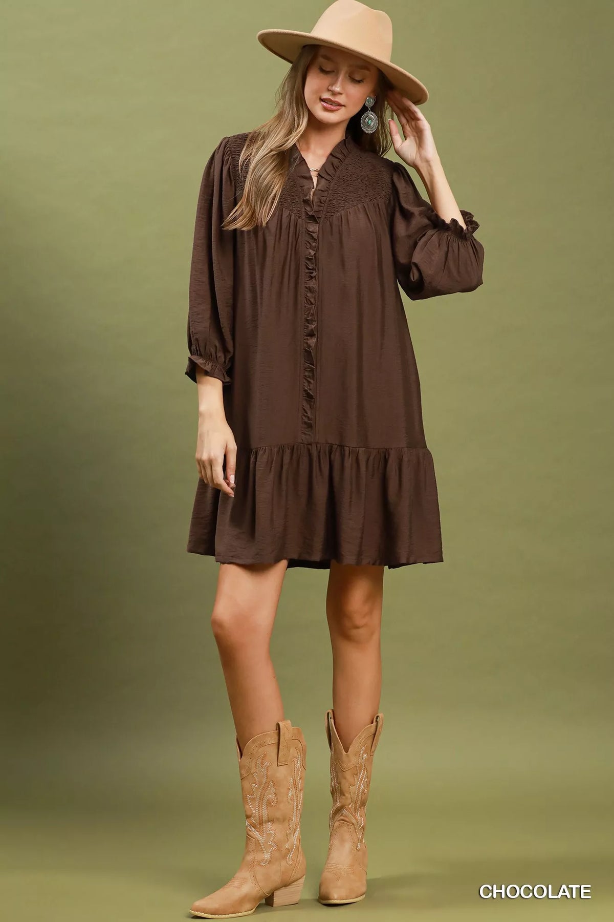 Chocolate-brown tiered mini dress with ruffled placket and skirt tiers, long puff sleeves.
