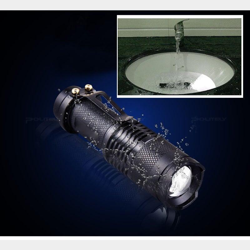 Black waterproof mini LED flashlight emitting bright beam with water splash effect