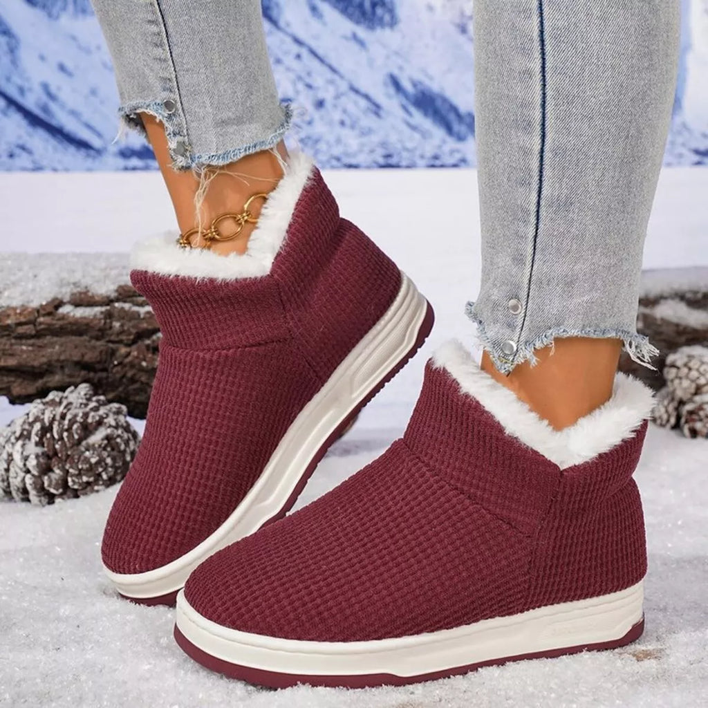 Burgundy knit ankle boots with plush white lining and cushioned platform sole