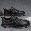 Black leather-look low-top canvas sneakers with lace-up front and rubber sole.