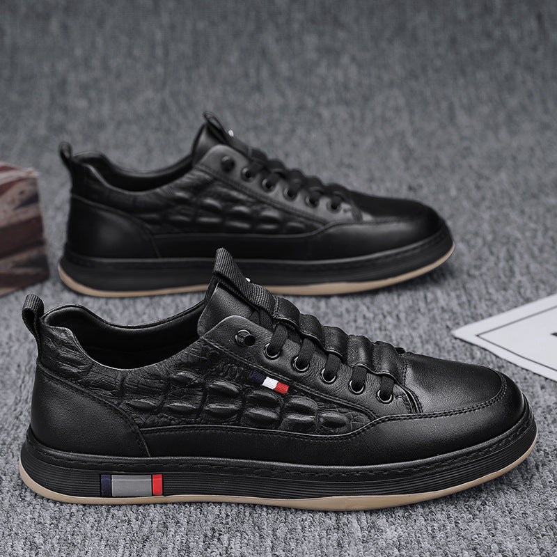 Black leather-look low-top canvas sneakers with lace-up front and rubber sole.