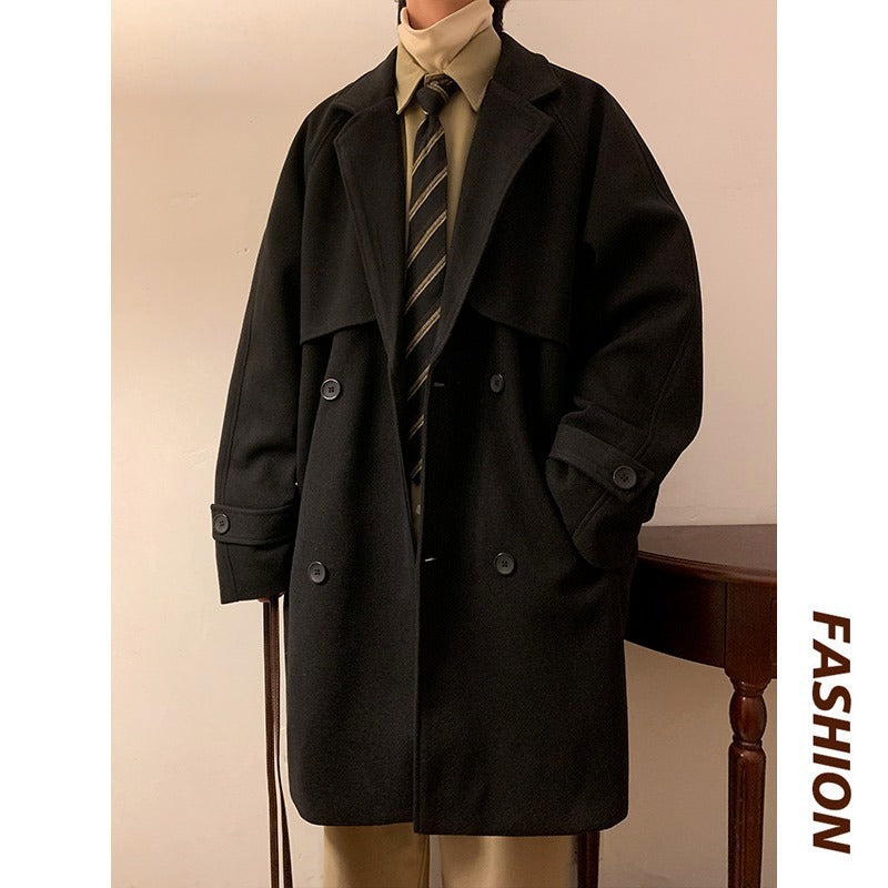 Black mid-length wool overcoat with wide lapels, double-breast buttons, and cuff tabs