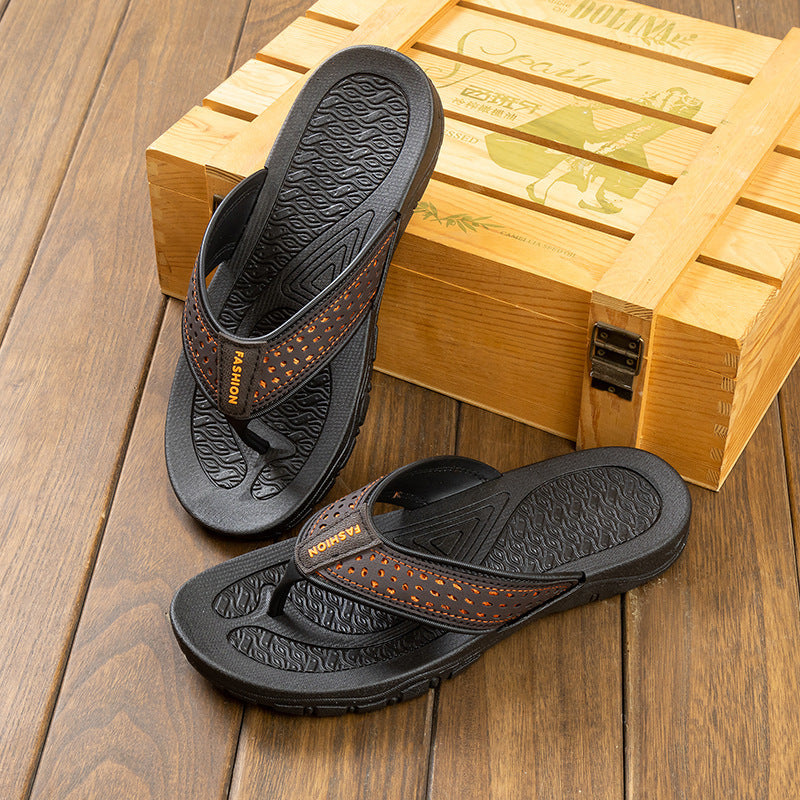 Men's black flip-flop sandals with orange perforated strap and textured rubber soles