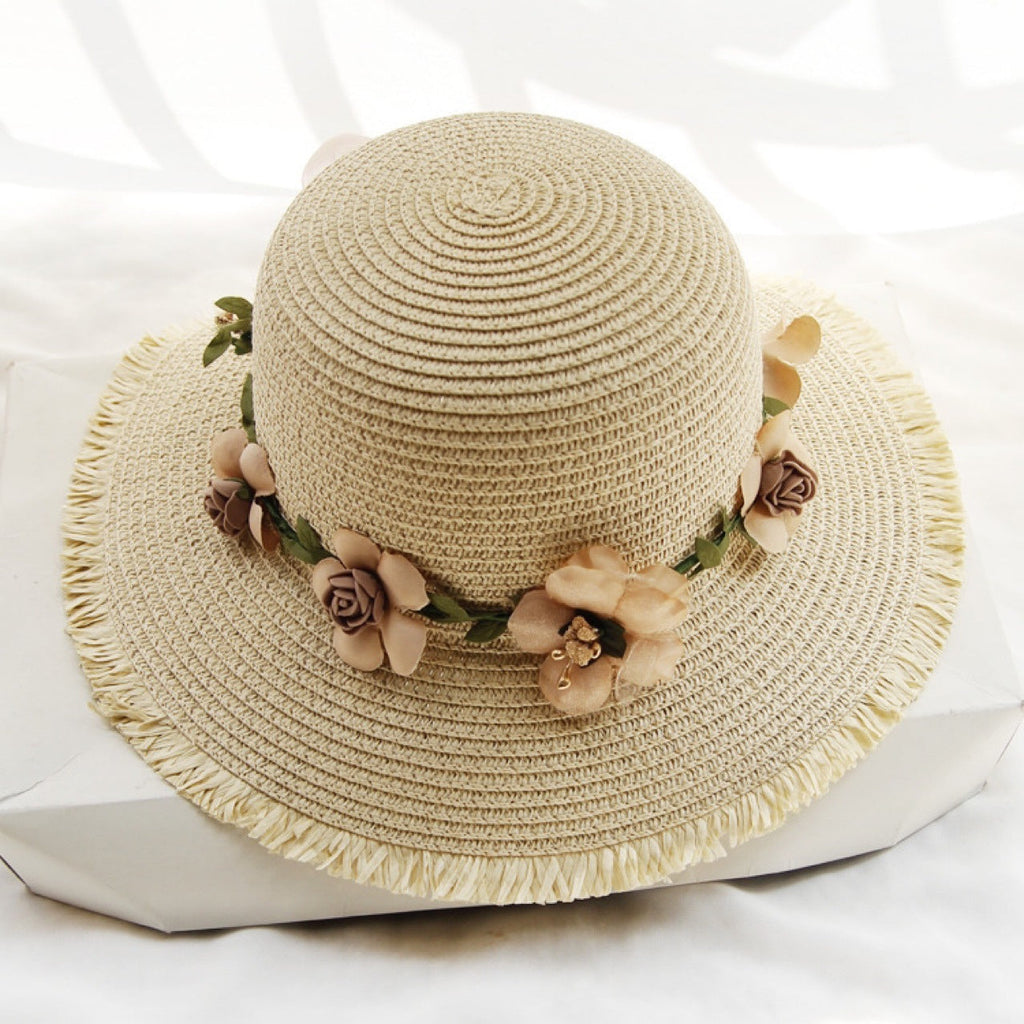 Womens straw sun hat in light beige with floral trim around the crown
