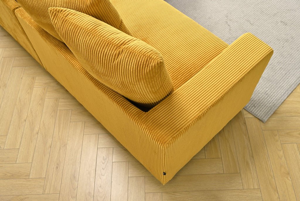 L-shaped sectional sofa with chaise, mustard yellow corded upholstery with chaise arm