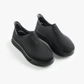 Pair of black 3D printed slip-on sneakers with ribbed upper and cushioned sole