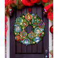 12 Days of Christmas door wreath with colorful numbered ornaments and green foliage