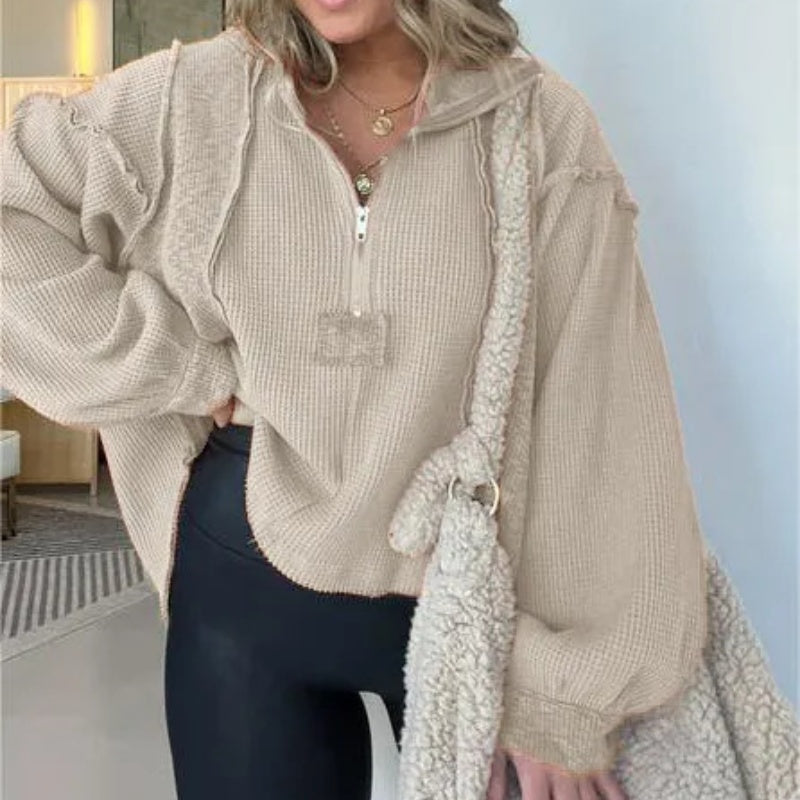 Cream quarter-zip sweater with textured knit, contrast rope trim, and frayed hem