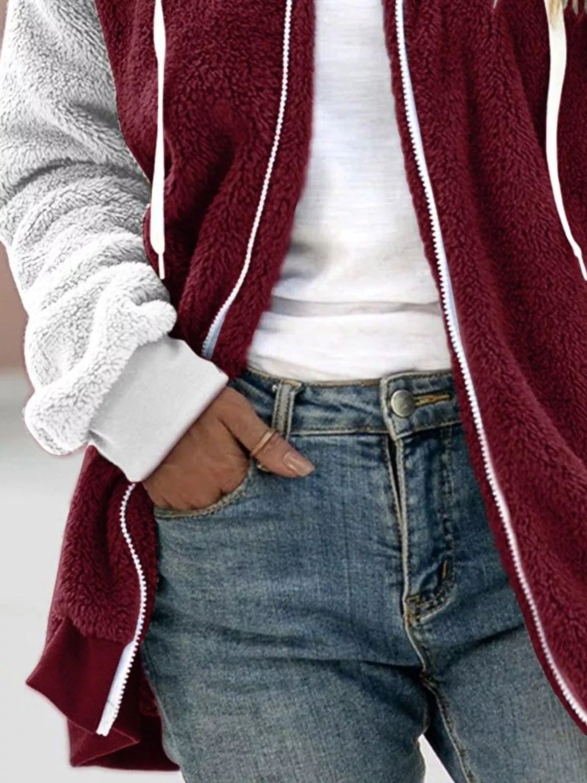 Burgundy fleece zip-up hoodie with white trim, drawstring hood, and light gray sleeve