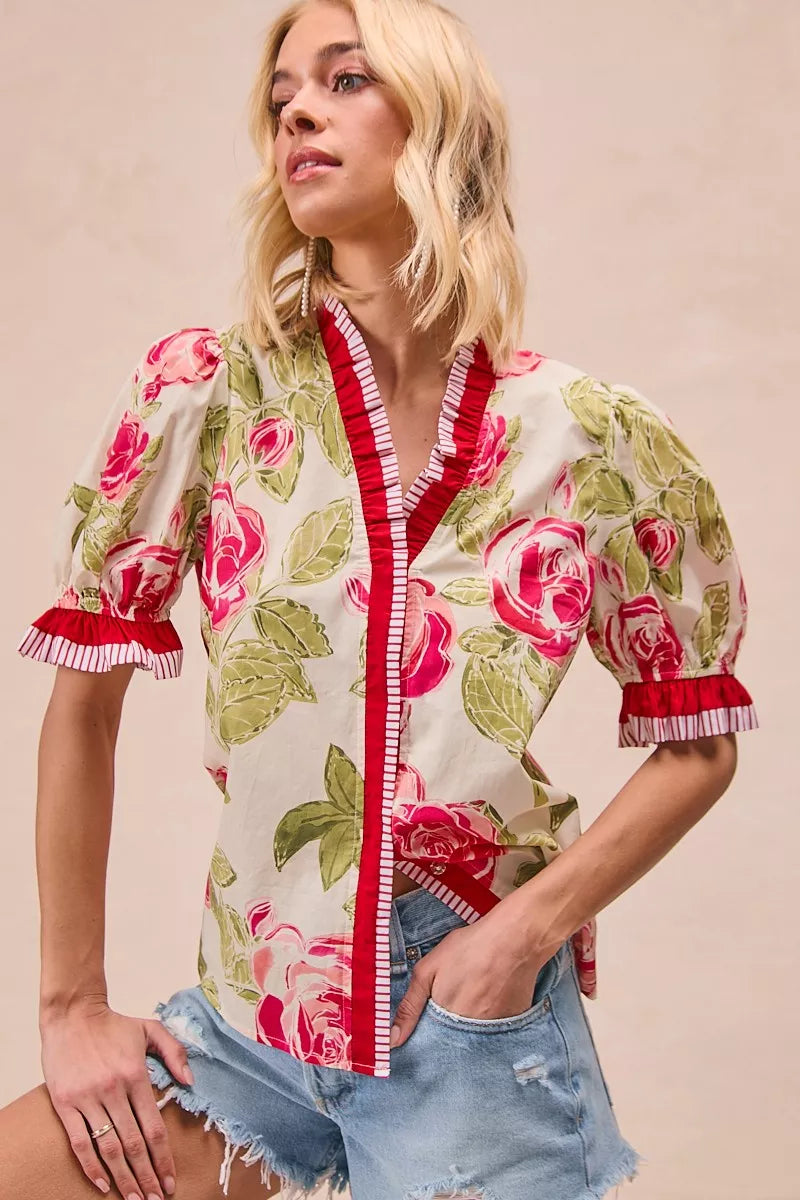 Floral woven blouse with coral contrast placket and puffed ruffle sleeves