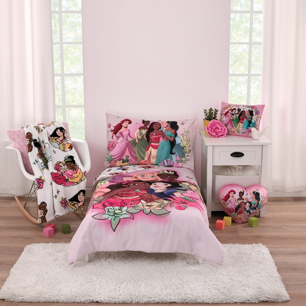 Princess graphic toddler pillow on bed, pink floral-detailed design