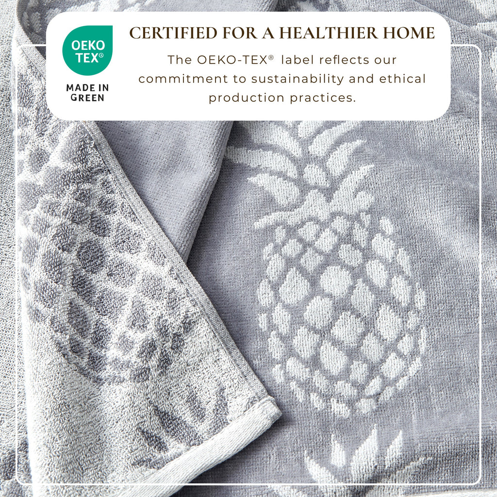 Gray cotton velour towel close-up with mixed floral and dotted pattern