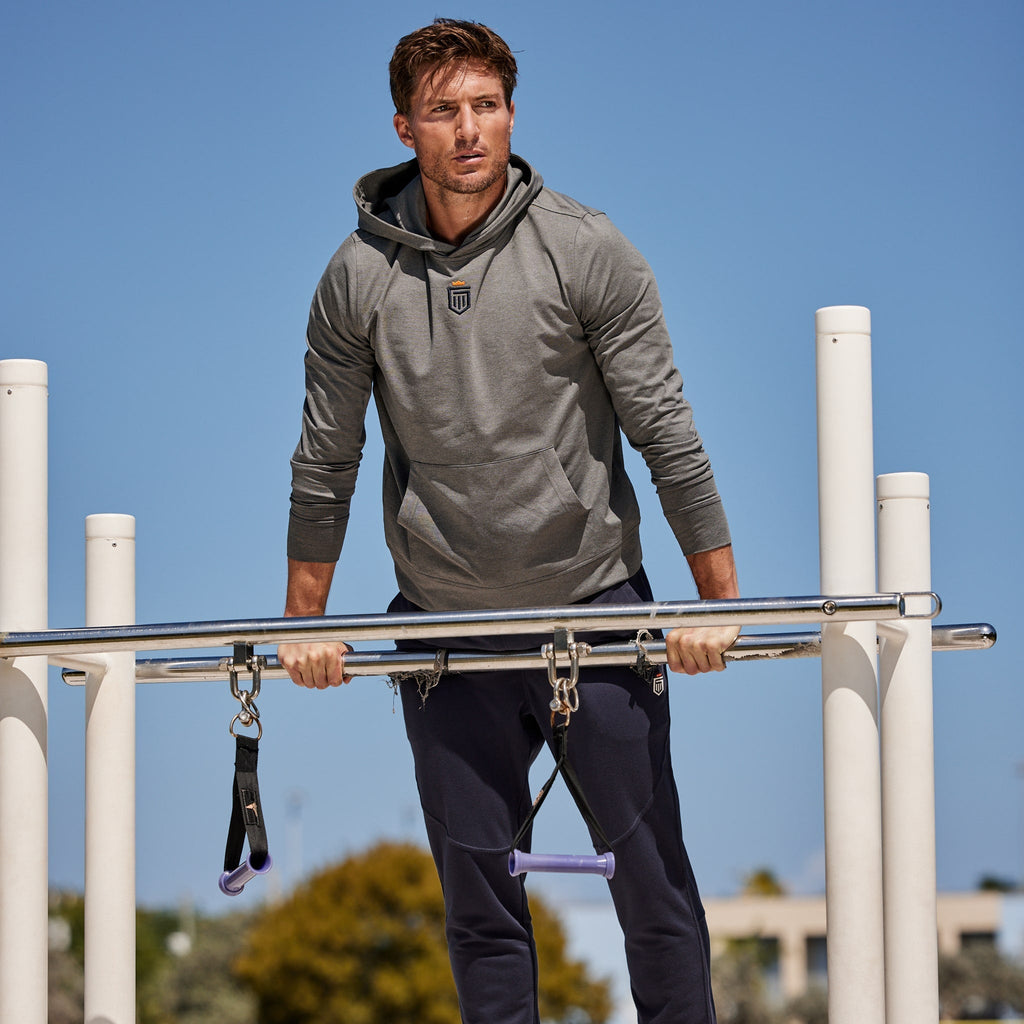 Navy jogger pants with tapered legs and elastic waistband, side pockets visible.