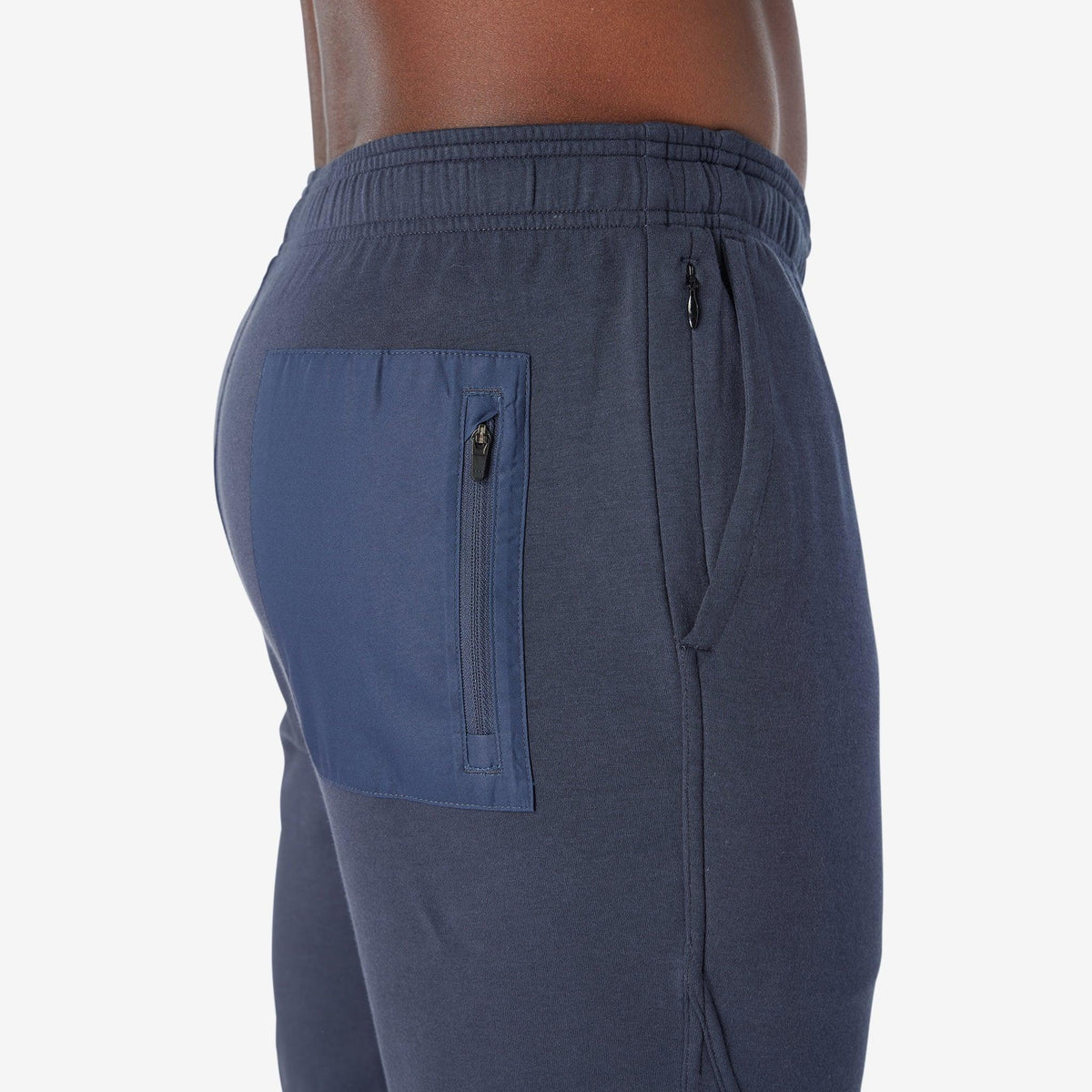 Navy jogger pants with back zip pocket and adjustable drawstring waist.