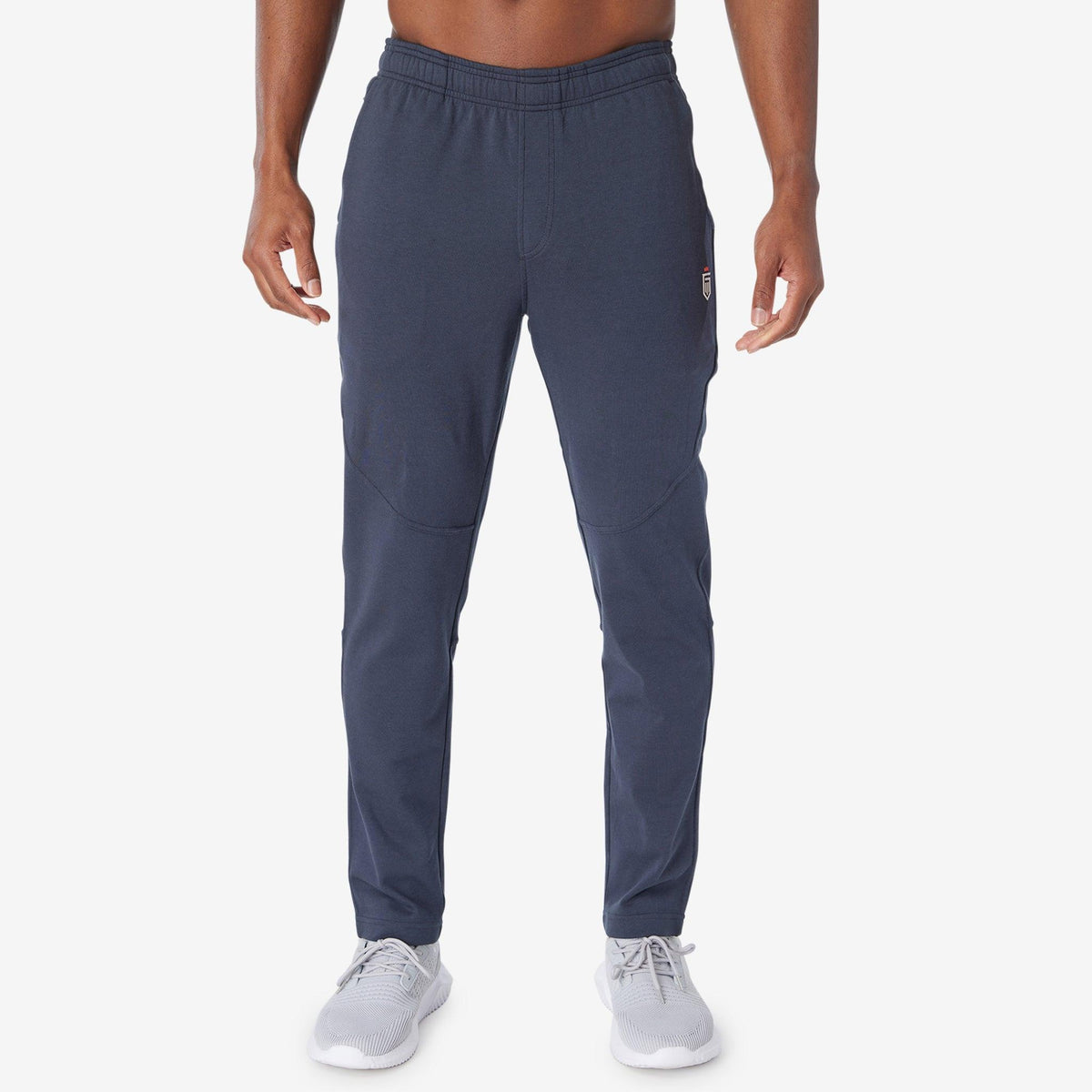 Navy jogger pants with drawstring waist, side pockets, and tapered fit.