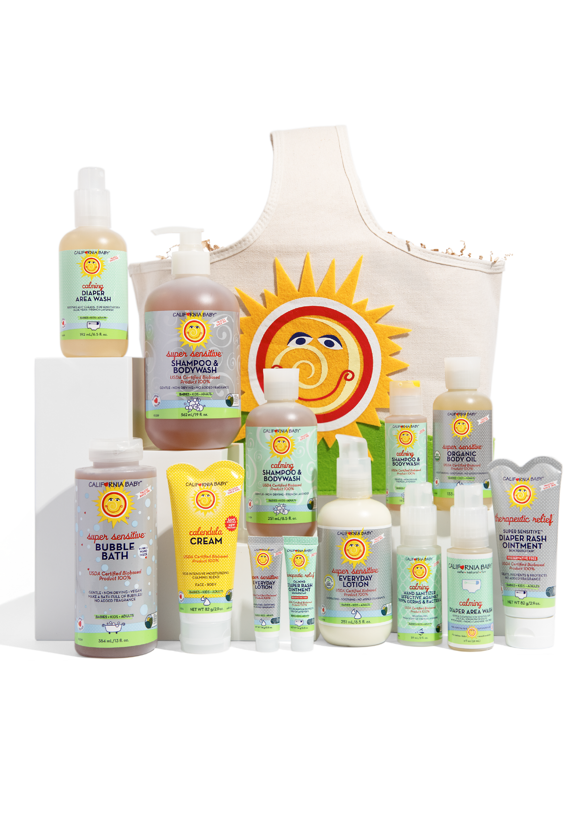 Assorted baby skincare bottles and pump, plus cream bib with sun and swirl