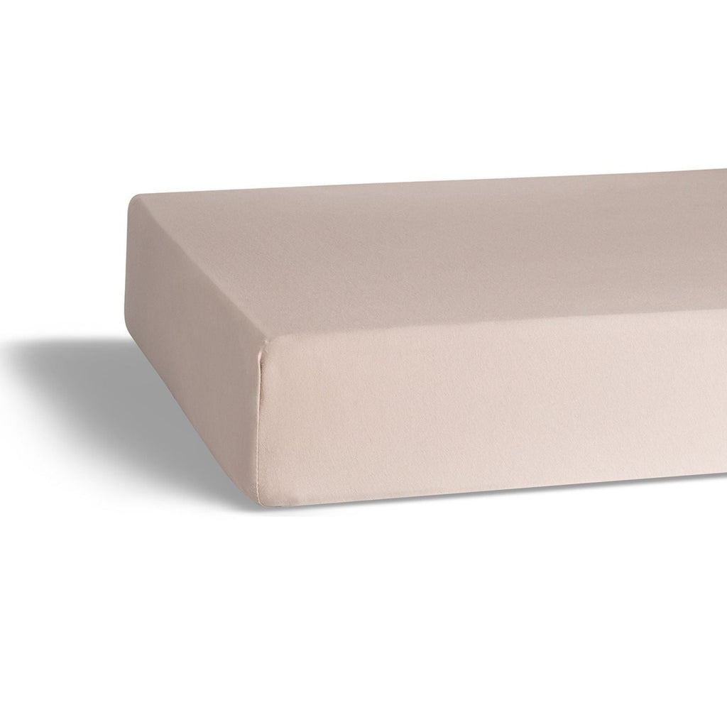 Light pink crib sheet mattress cover with fitted corner and clean edge