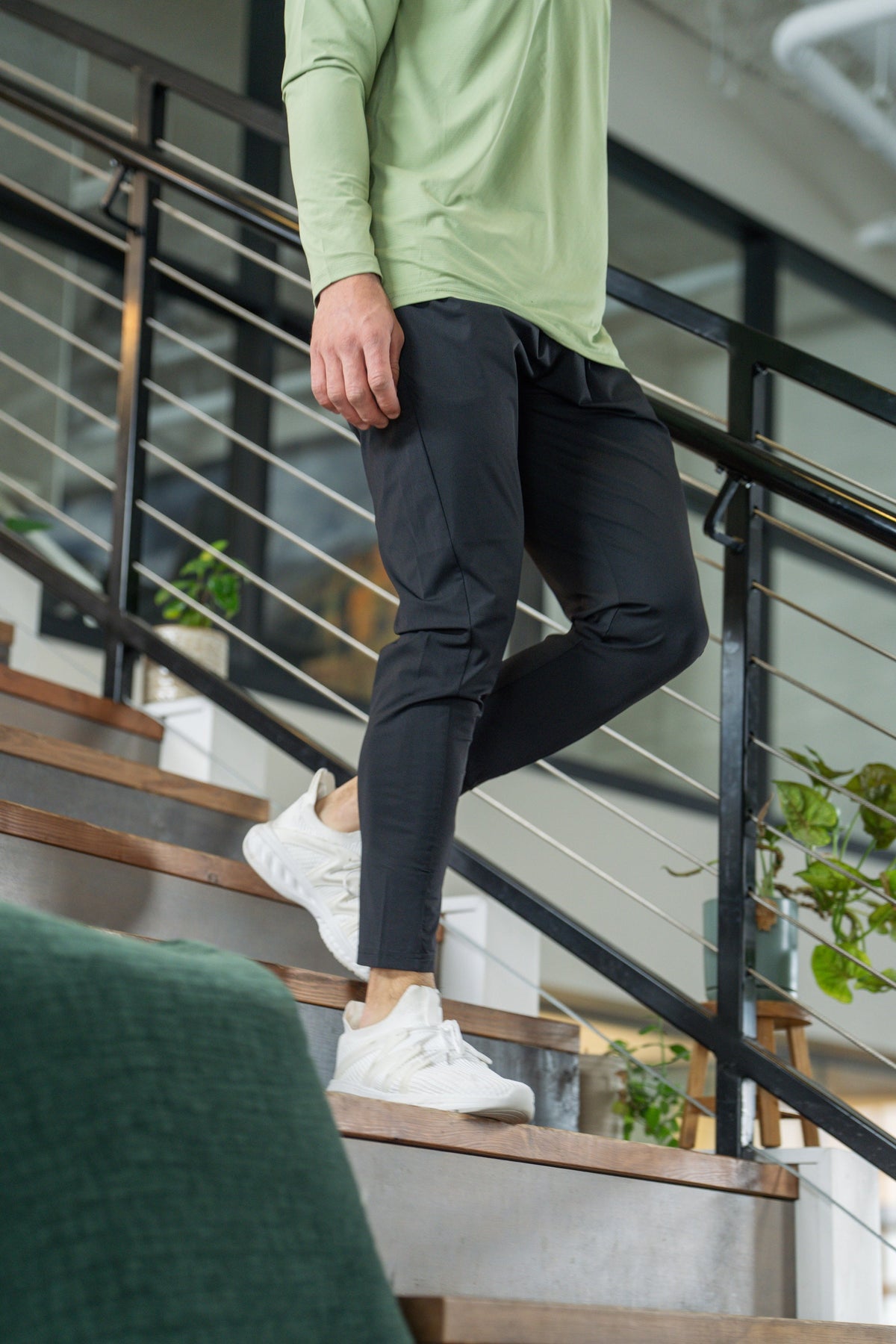 Black jogger-style pants with elastic waist, tapered legs, and side pockets