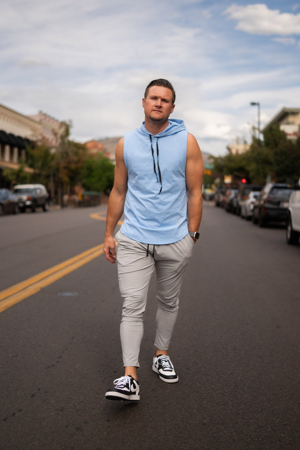 Light gray sleeved jogger pants with elastic waist, tapered legs, and side pockets
