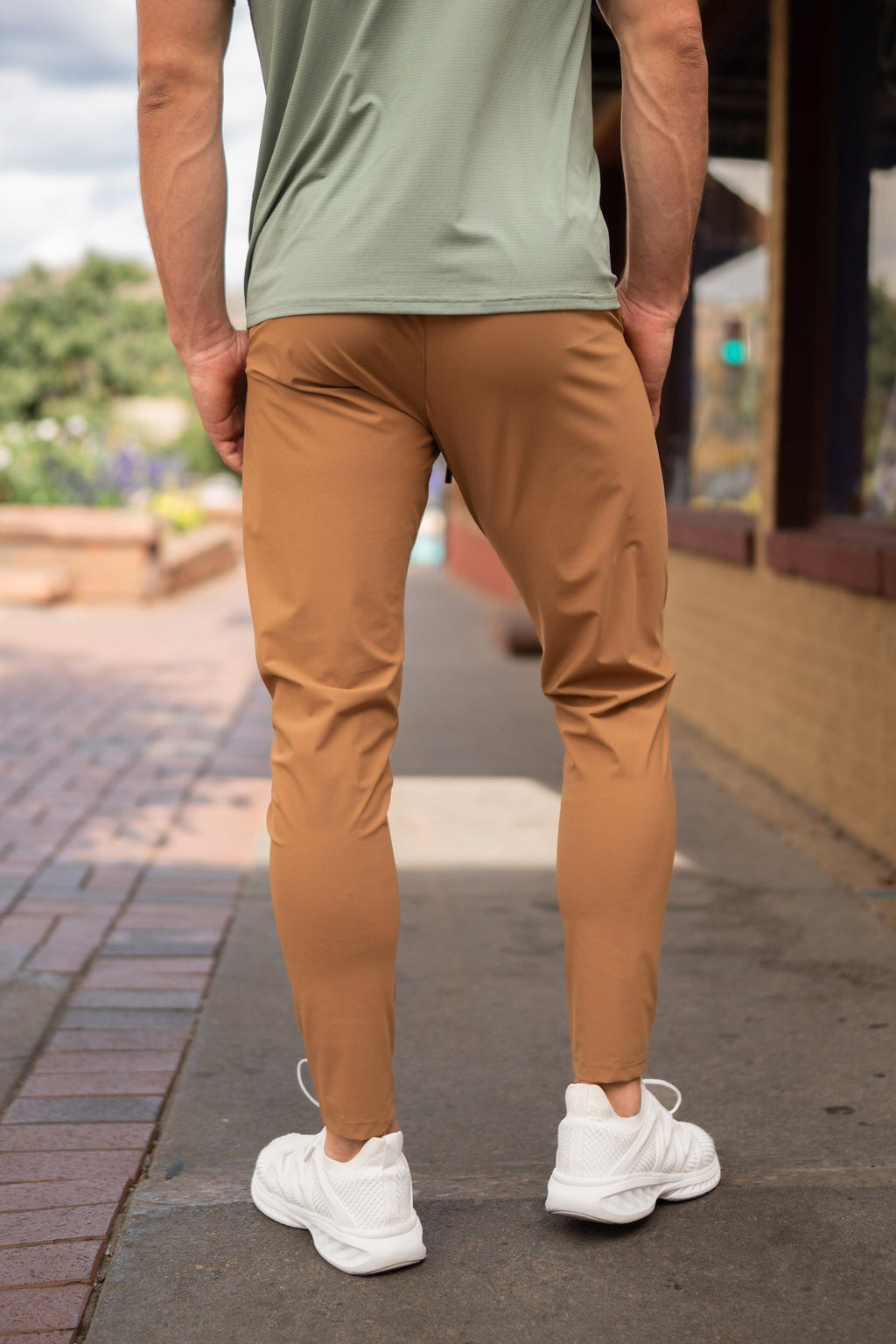 Warm tan jogger-style pants with elastic waist, tapered legs, and side pockets