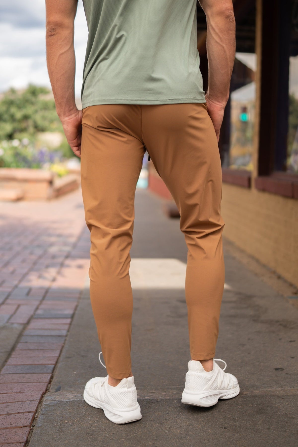Warm tan jogger-style pants with elastic waist, tapered legs, and side pockets