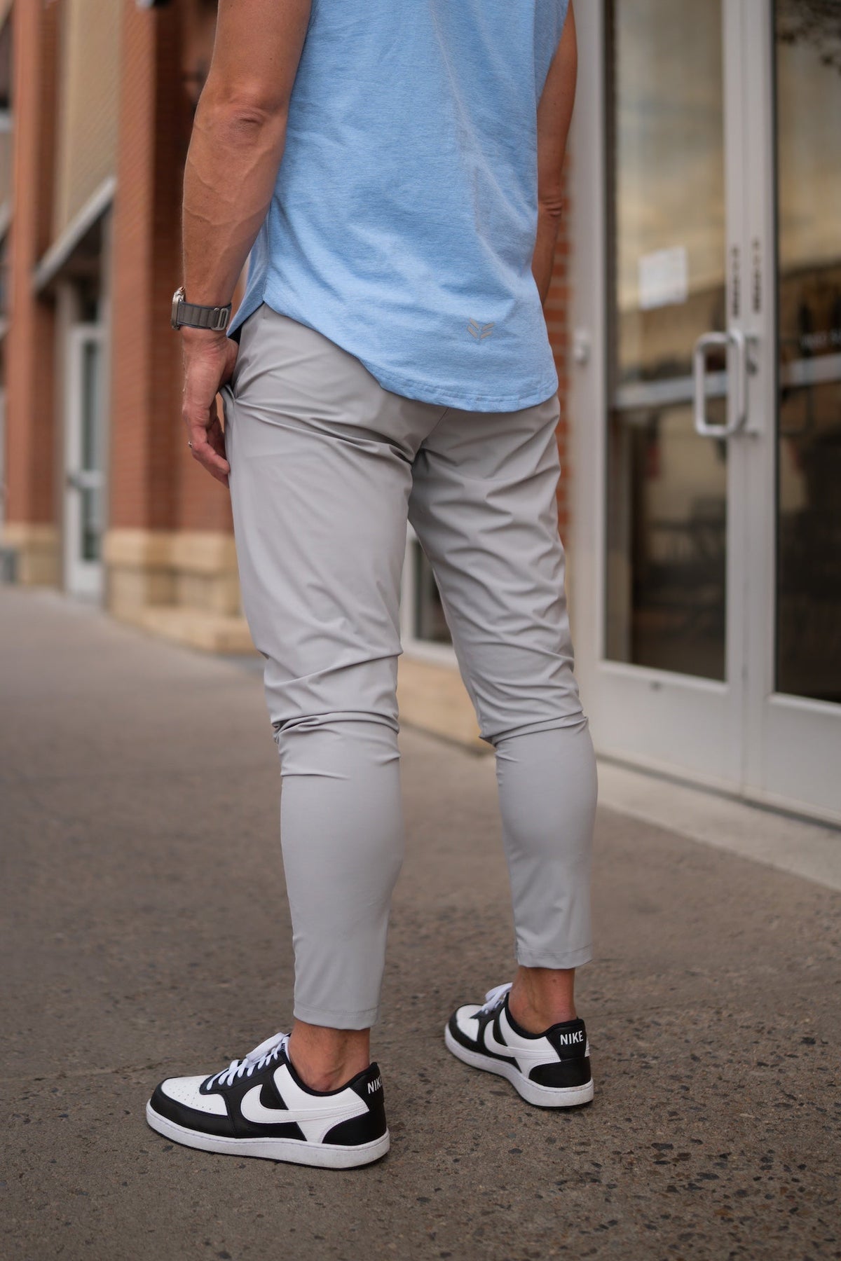 Light gray jogger-style pants with elastic waist, tapered legs, and side pockets