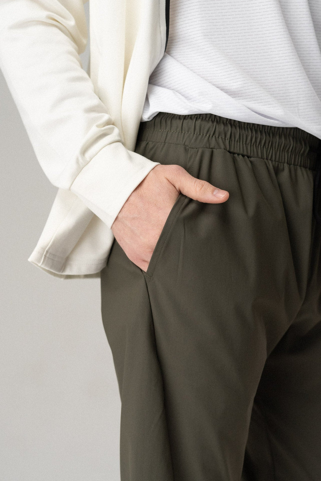 Dark olive pants with elastic waist and relaxed fit at the hips