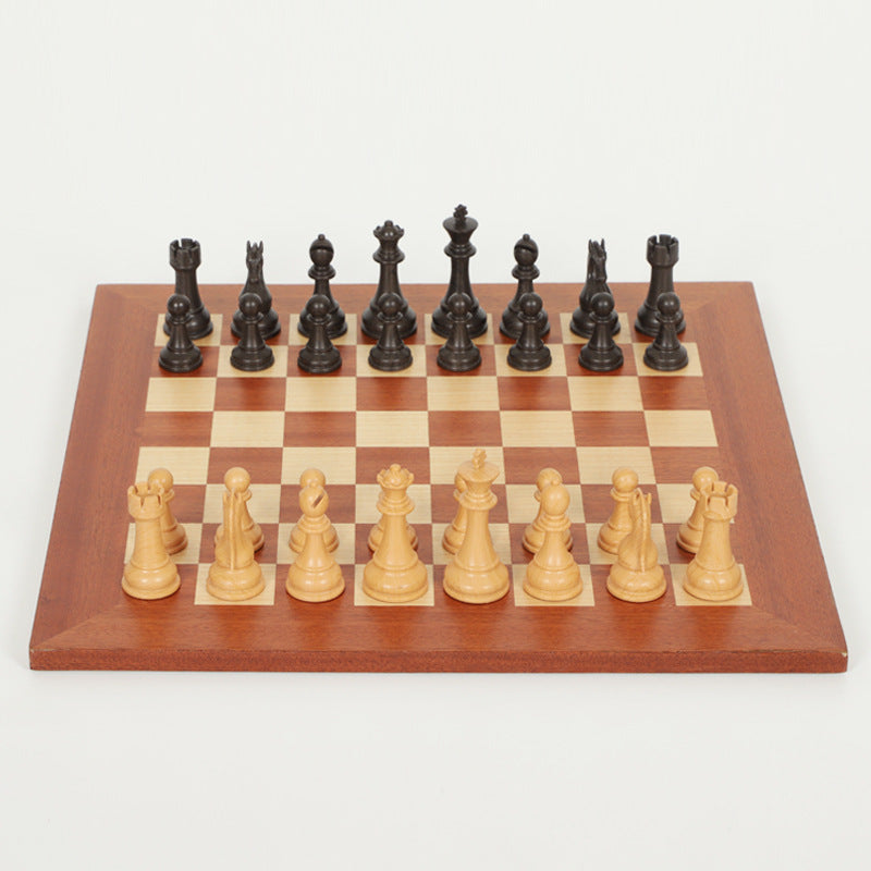 Wooden chessboard with black and beige chess pieces arranged for play