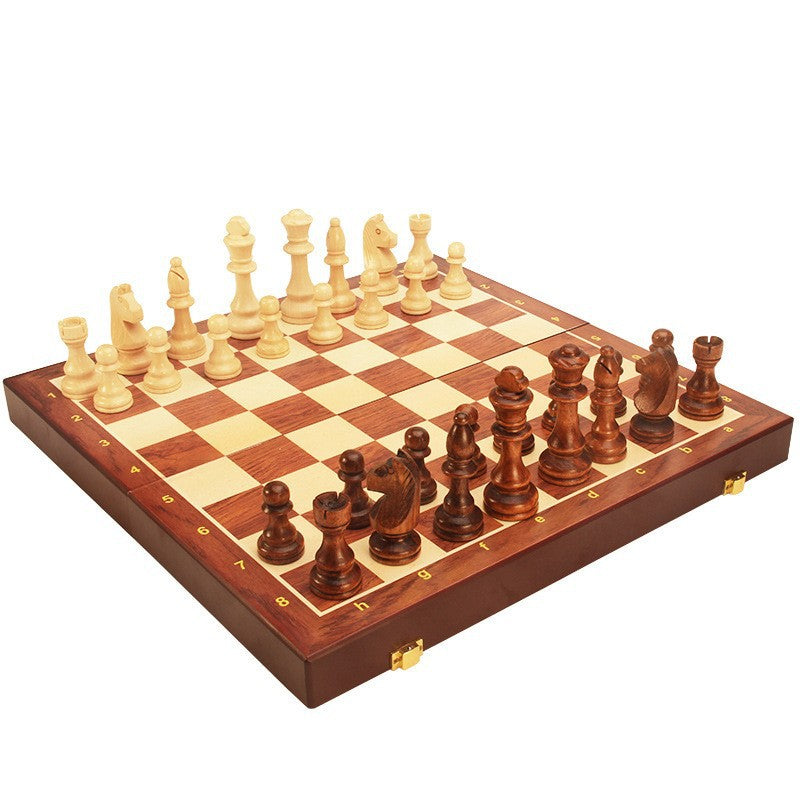 Wooden chess and checkers board with cream side and dark side pieces, angled view