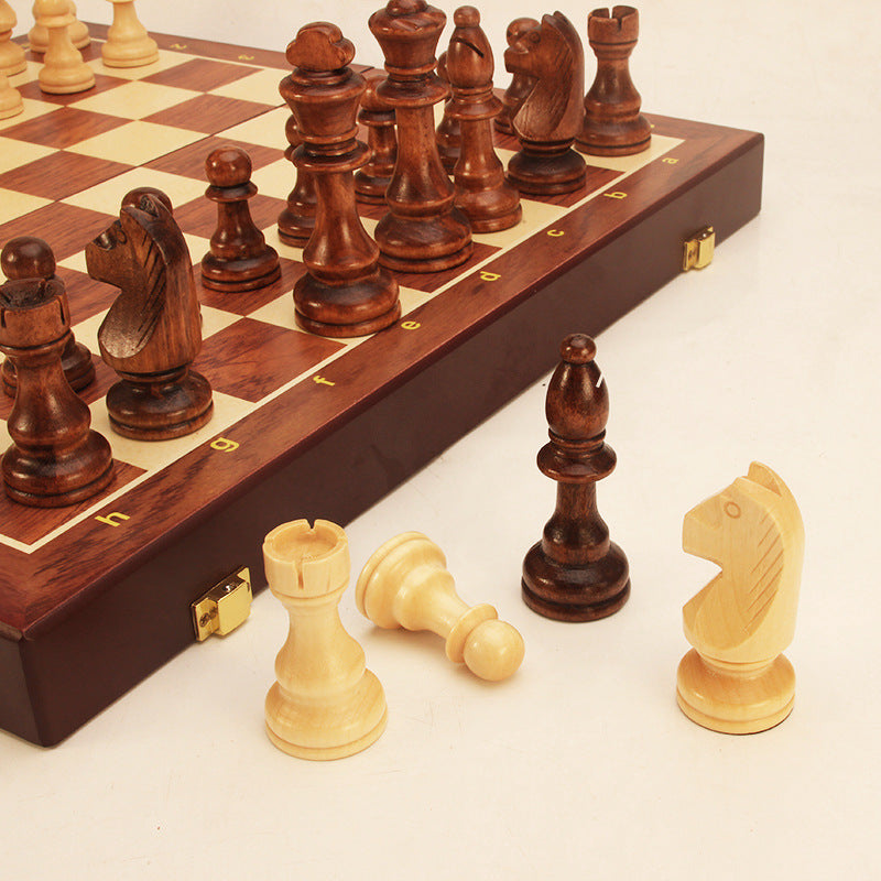 Wooden chessboard edge with dark pawn and rook pieces, pieces posed on squares